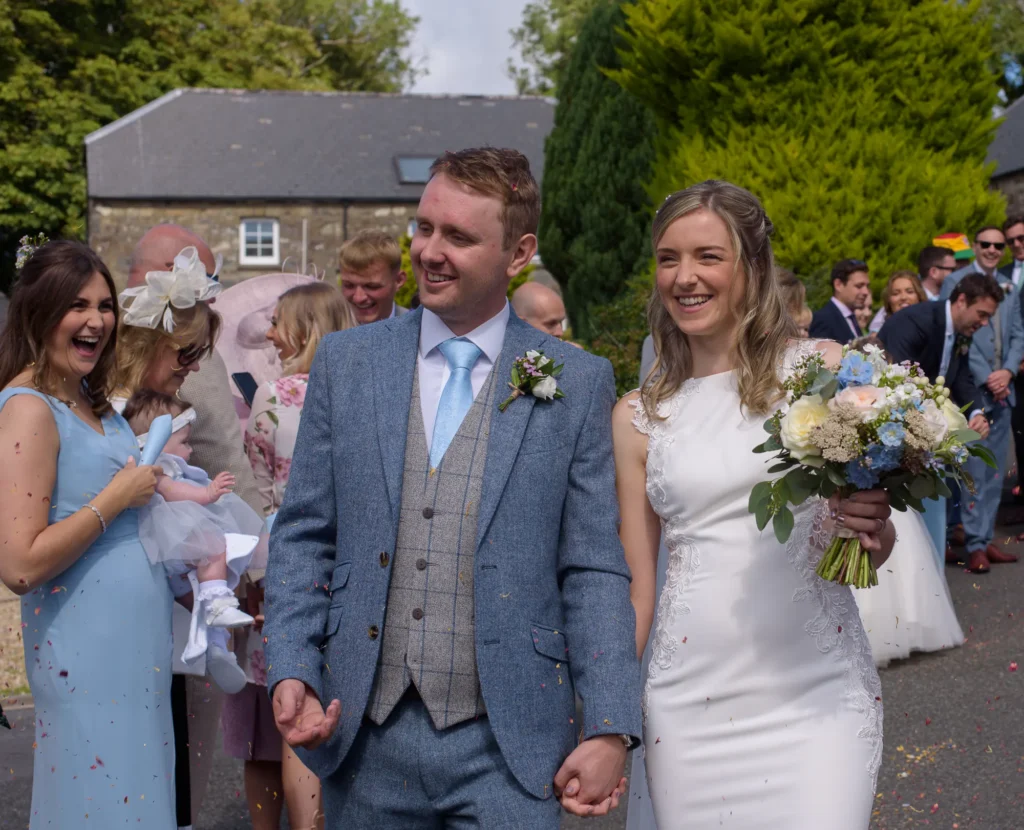 Bride-and-Groom- Confetti-Walk Photo of the bride and groom doing a confetti walk by dick Lloyd Photography