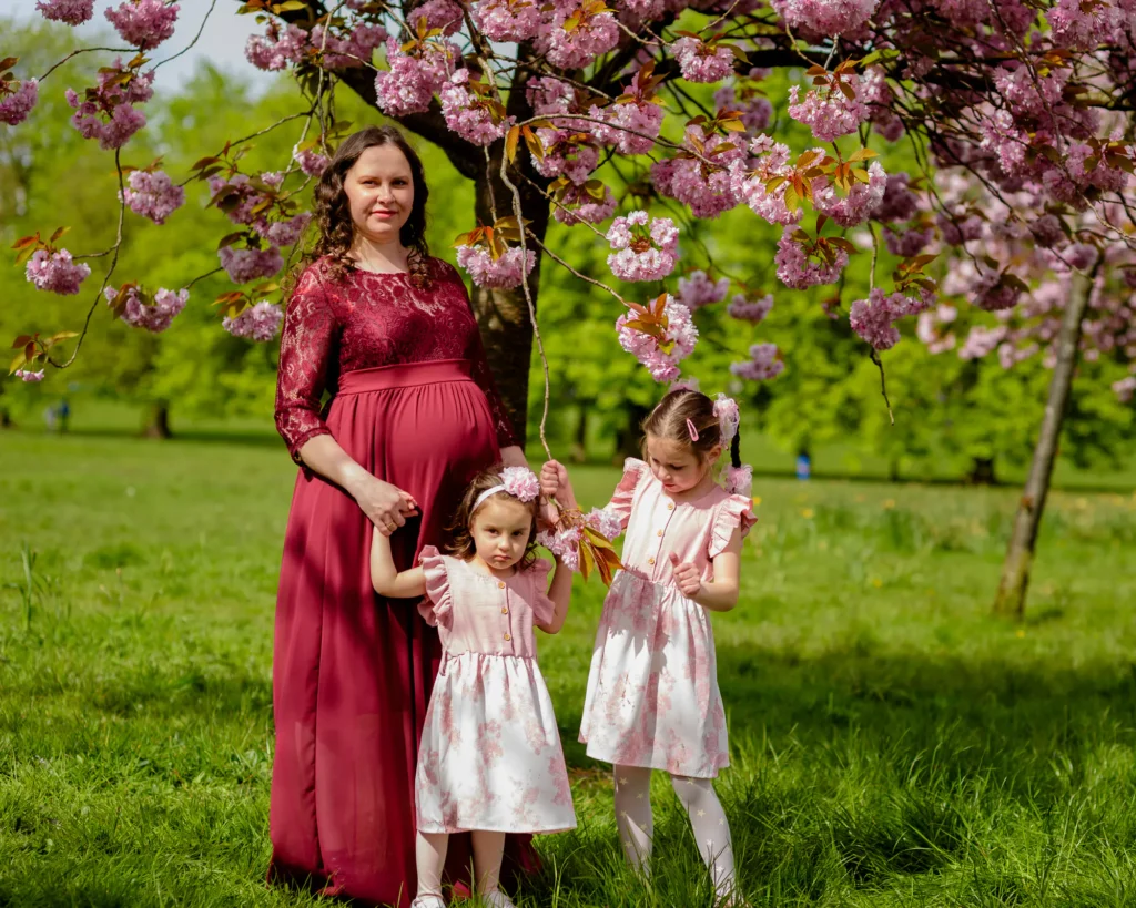 Maternity Photography in Harrogate - Iryna with her two daughters under a cherry tree in blossom - by dsick Lloyd Photography