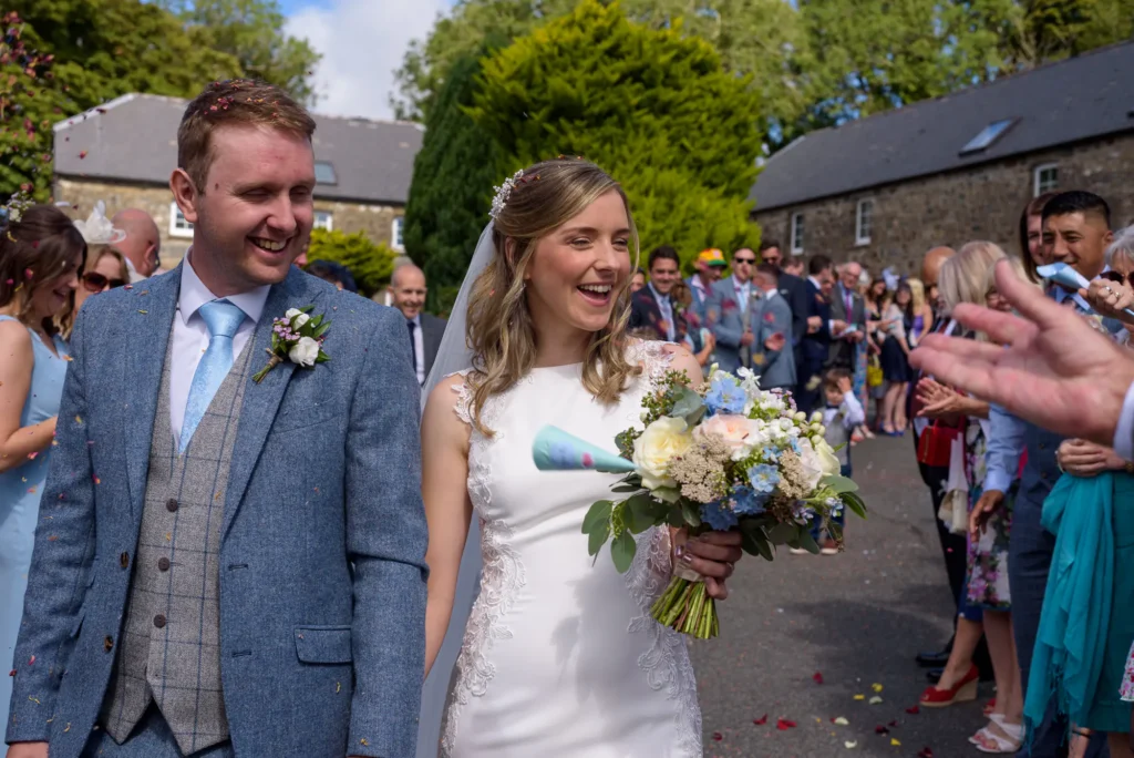 Angharad & Lewis Wedding-1068 The bride and groom in the confetti walk, captured by Dick Lloyd Photography