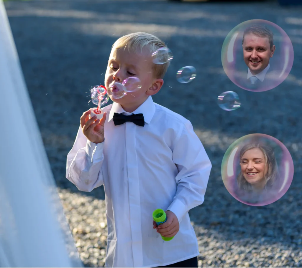 Angharad & Lewis Wedding-1447-Edit-2 Creative composite - young boy blowing bubbles with two of the bubbles containing images of the bride and groom, created by Dick Lloyd Photography