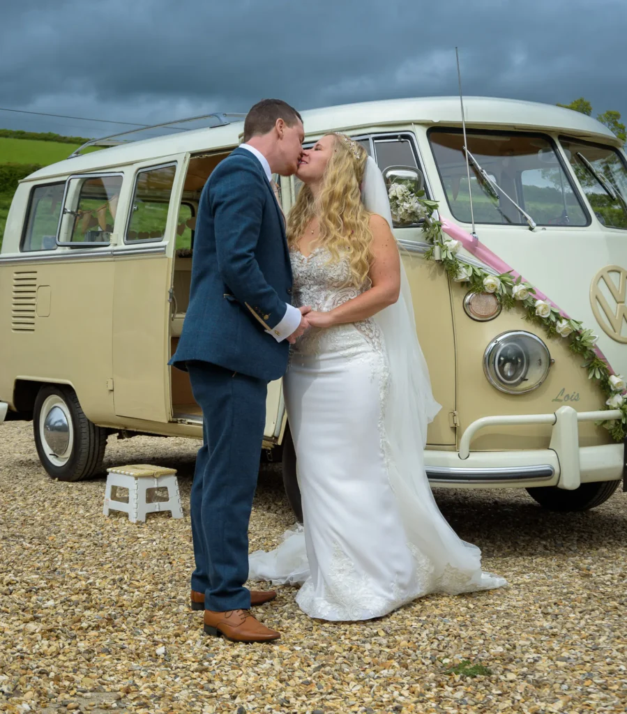 Timeless Memories Collection – Bride and Groom with VW Camper Wedding Photography by Dick Lloyd Bride and groom kissing in front of a vintage VW camper van on their wedding day, photographed by Dick Lloyd Photography, a Yorkshire wedding photographer.
