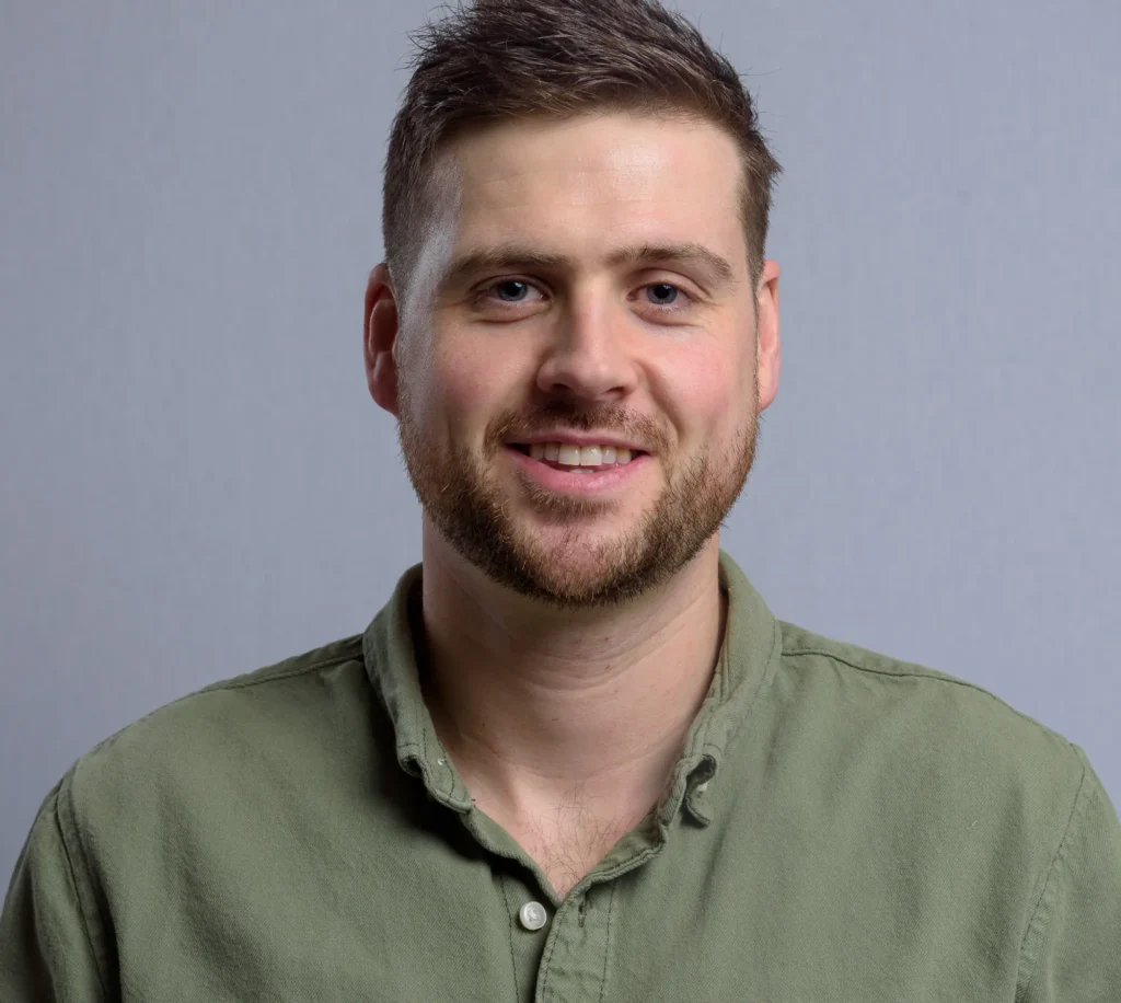 Corporate headshot in Harrogate - man wearing a casual shirt shot with a grey background