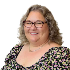 Woman wearing floral dress and glasses - headshot with white background
