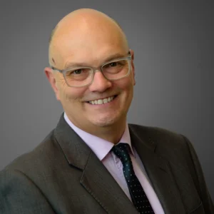 Businessman in suit and tie - headshot with grey background