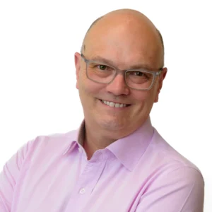 Businessman wearing glasses in pink shirt - corporate headshot with white background