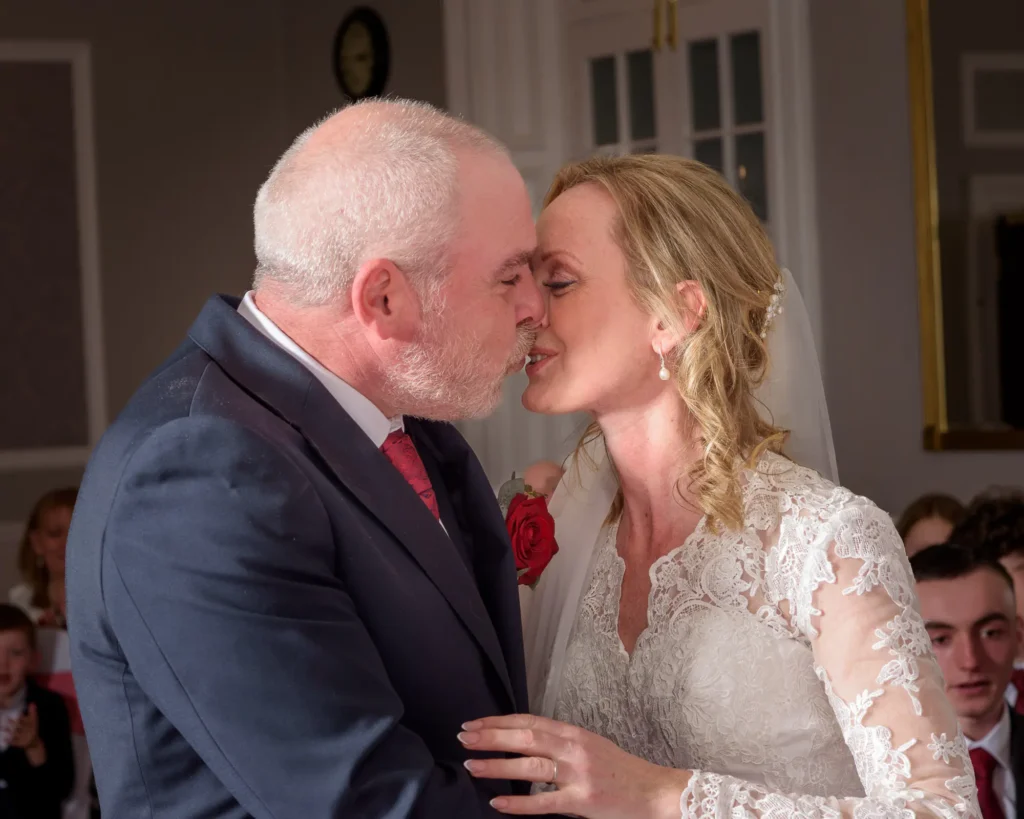 Eternal Elegance Collection – Complete Wedding Day Coverage Wedding photography in Yorkshire - Bride and groom sharing their first kiss during a Yorkshire wedding, captured by Dick Lloyd Photography.